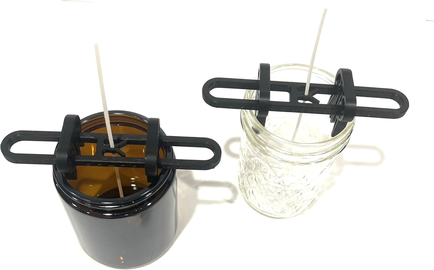 Wick centering tools on amber and clear jars